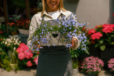 Portrait of young woman holding bouquet