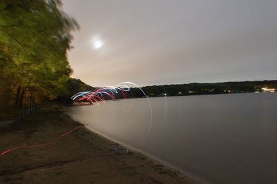 View of illuminated lights in water at night