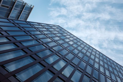 Low angle view of modern building against blue sky