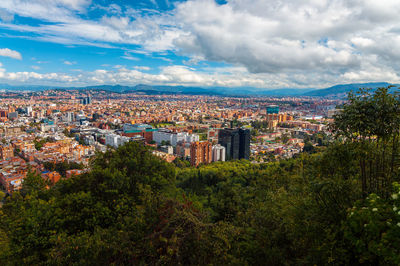 High angle view of trees against cityscape