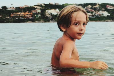 Portrait of shirtless boy in sea