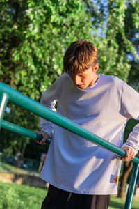 Side view of young woman standing in park