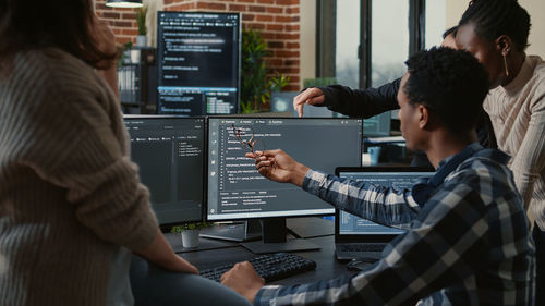 Colleagues working on computer in office