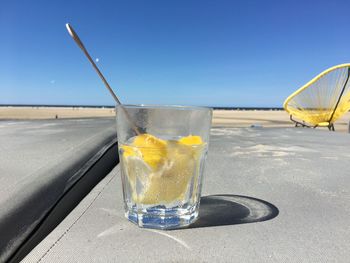 Close-up of drink on table against sky