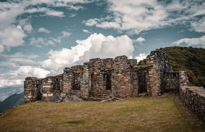 Old ruin on field against sky