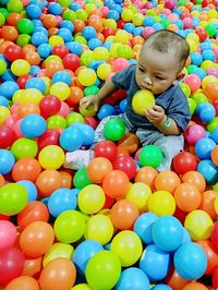 Cute boy playing in ball pool