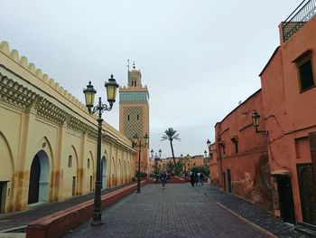 Street amidst buildings against sky in city