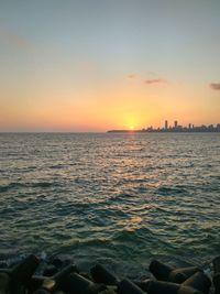 Scenic view of sea against clear sky during sunset