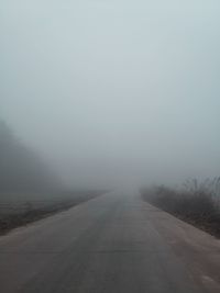 Empty road against sky during winter