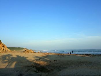 Scenic view of beach against blue sky