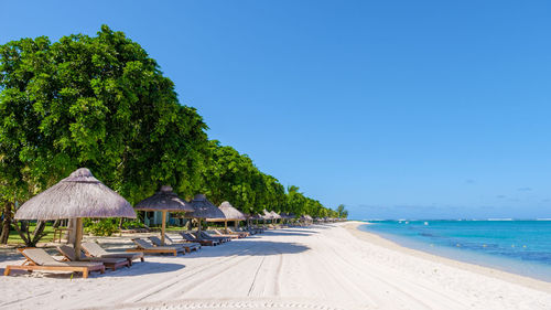 Scenic view of beach against clear blue sky