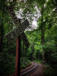 Road sign by trees