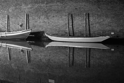 Chairs and table against moored boats