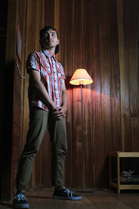 Full length of young man standing at home