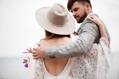 Bride and bridegroom standing at beach during wedding ceremony