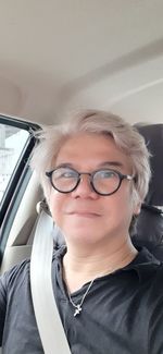 Portrait of smiling woman in car