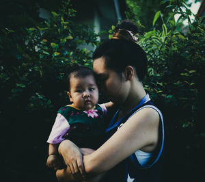 Mother and baby girl with arms raised