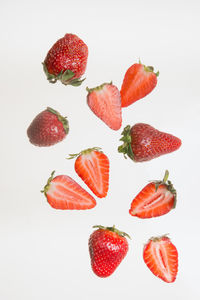 Slices of fresh strawberries on white background