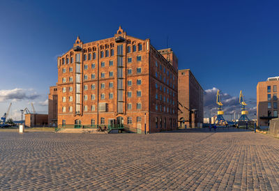 Buildings in city against blue sky
