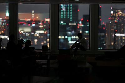 Silhouette people in restaurant at night