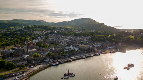 High angle view of townscape by river against sky