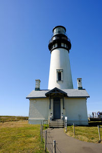 Low angle view of lighthouse against clear blue sky