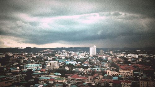 Cityscape against cloudy sky