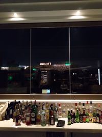 Illuminated bottles in restaurant at night