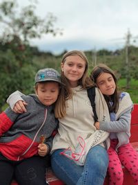 Cute smiling girls sitting outdoors