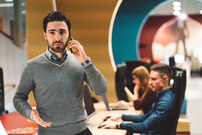 Side view of young man using mobile phone