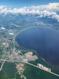 Aerial view of sea and landscape against sky