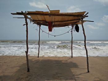 Lifeguard hut on beach against sky