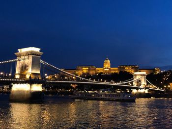 Illuminated chain bridge over danube river at night