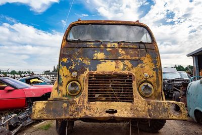 Old rusty car against sky