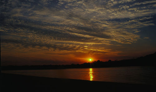 Scenic view of sea against romantic sky at sunset