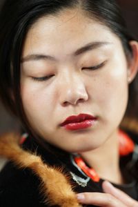 Close-up of young woman looking down