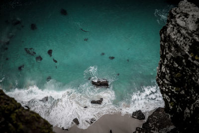 High angle view of rocks in sea