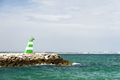 Lighthouse against calm blue sea