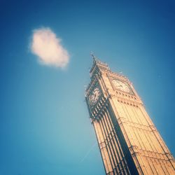 Low angle view of tower against blue sky