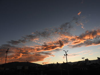 Low angle view of silhouette trees against sky at sunset