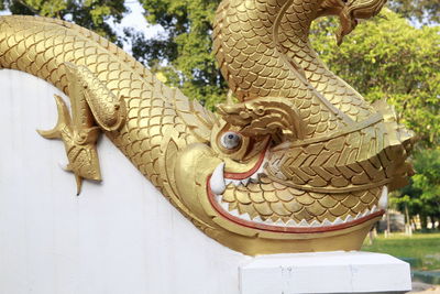 Close-up of buddha statue against wall