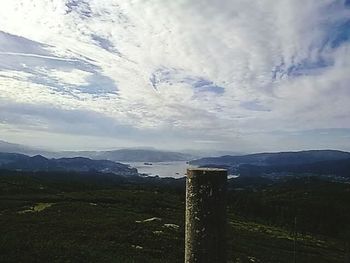 Scenic view of landscape against cloudy sky