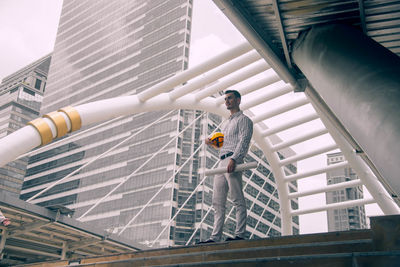 Low angle view of man standing on staircase of building