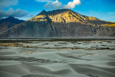 Scenic view of lake against cloudy sky