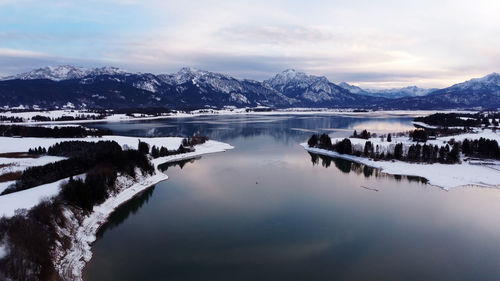 Scenic view of lake against sky during winter