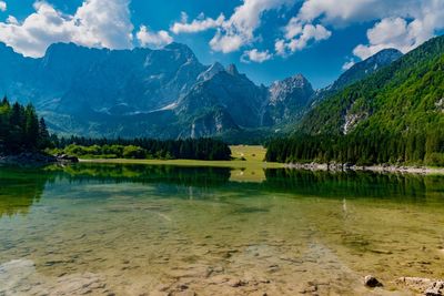 Scenic view of lake and mountains against sky