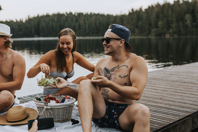 People sitting by lake