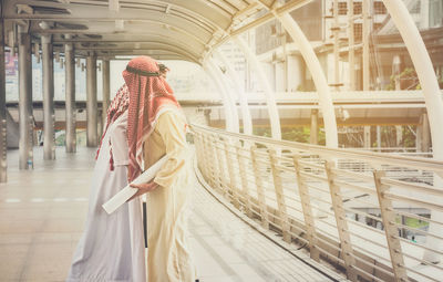 Rear view of women walking in corridor of building