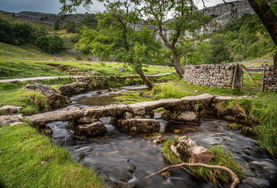 Old stone clapper bridge at malham cove in the yorkshire dales, england, uk.