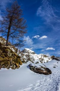 Scenic view of snow covered mountains against sky